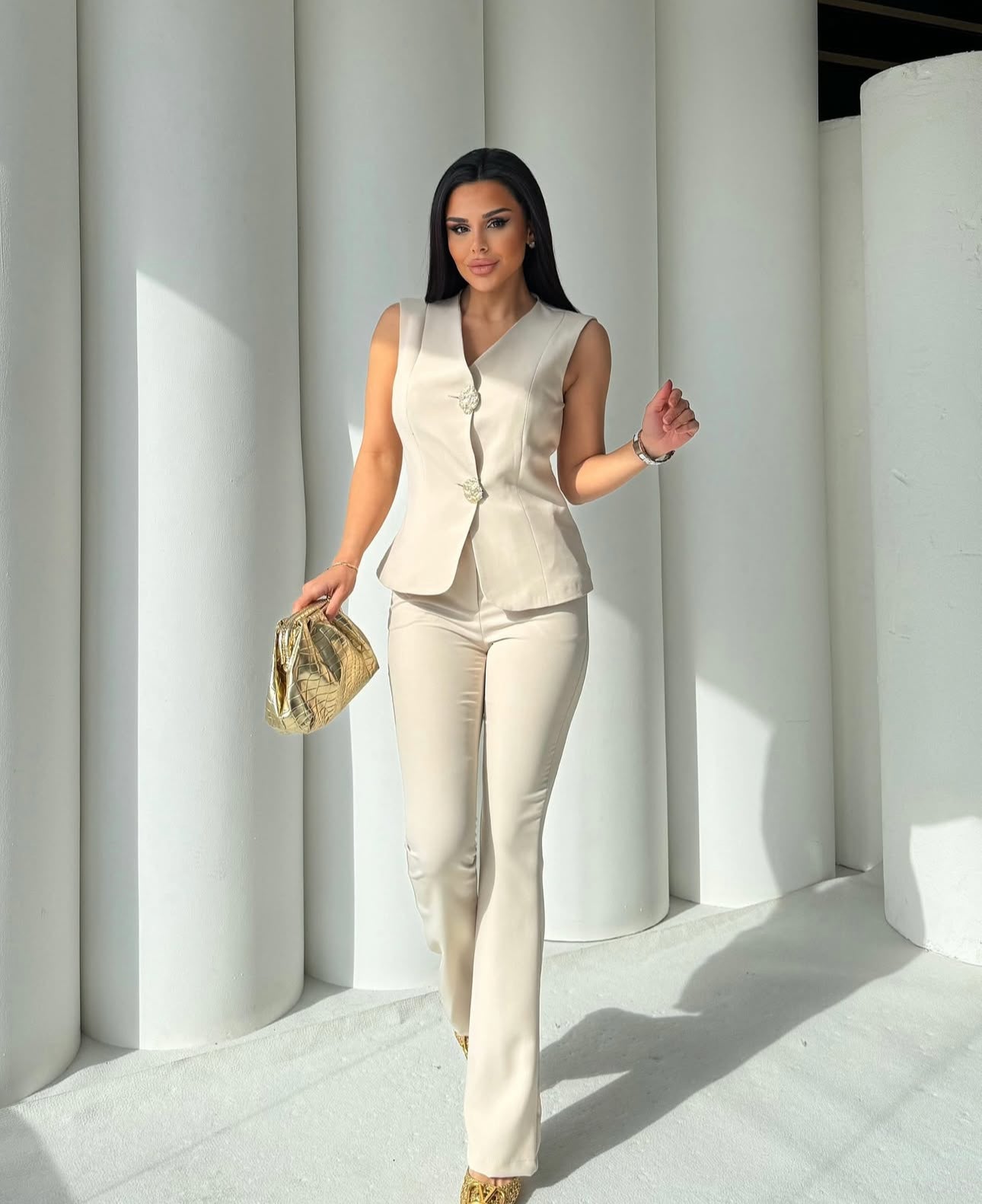 Set cord PERLA elegante composto da un gilet smanicato e un paio di pantaloni a gamba larga Il gilet presenta due bottoni decorativi centrali dal design gioiello. I pantaloni sono a vita alta, con una vestibilità morbida e fluida