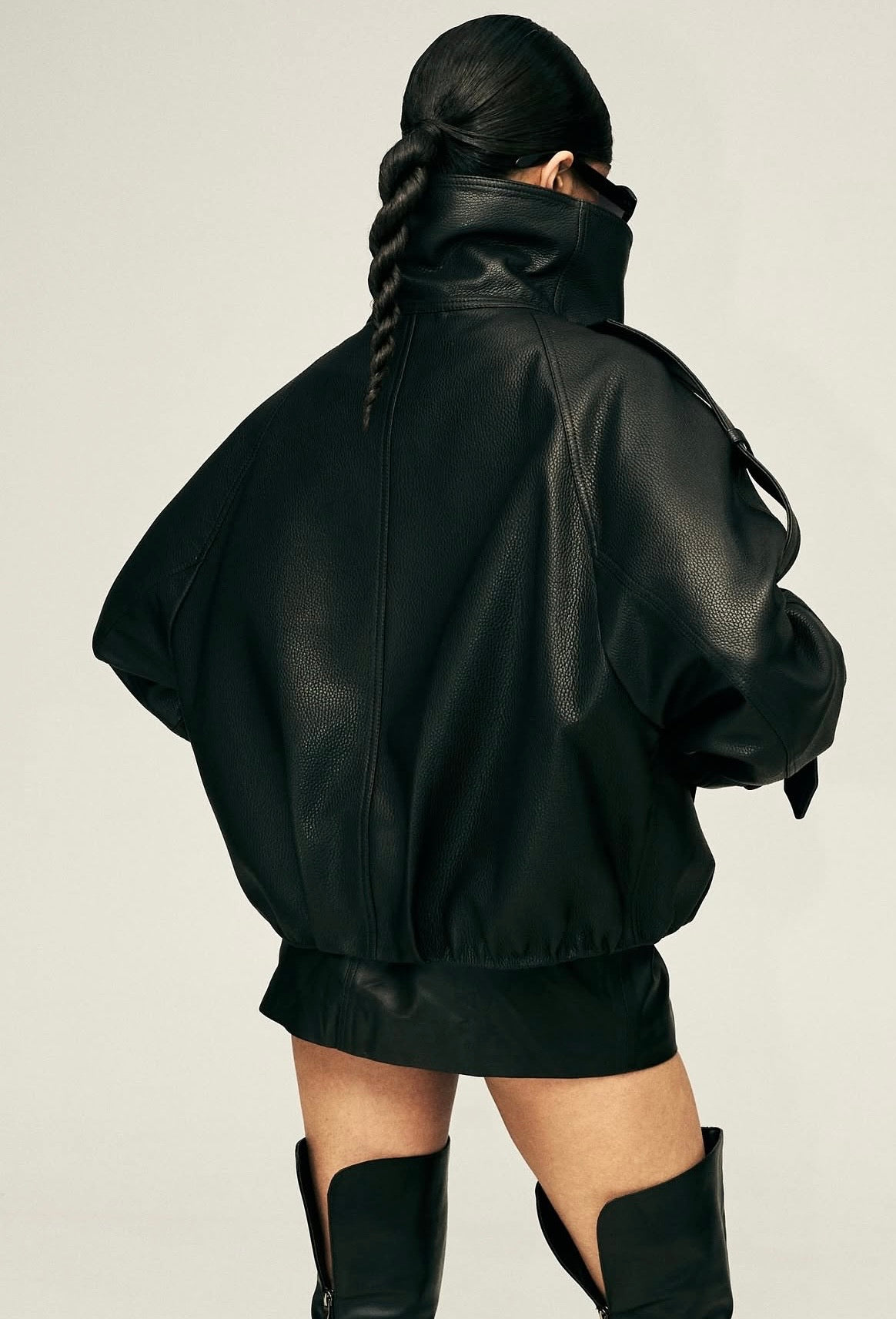 Eleva il tuo stile urbano con questo iconico giubbotto biker bomber oversize. Un capo che fonde la grinta della giacca in pelle al design d'avanguardia: caratterizzato da un imponente collo alto strutturato, allacciatura al petto