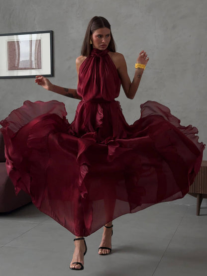 Abito Rouches maxi dress con scollo all'americana, collo con fiocco e gonna a cascata di rouches multistrato pensato per chi vuole essere al centro della scena senza sforzo. La silhouette fluida e il tessuto leggero lo rendono perfetto