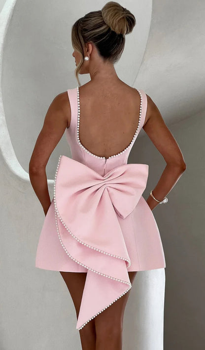 Mini Dress ALESSIA caratterizzato da un design sofisticato e femminile. Presenta una scollatura profonda sulla schiena, impreziosita da un bordo di perline che segue il profilo delle spalline e il décolleté posteriore…