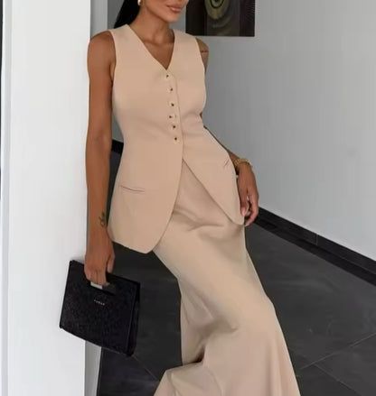 Tailleur ANTONELLA elegante in stile sartoriale è composto da un gilet senza maniche con scollo a V e chiusura a bottoni frontali. La gonna lunga e dritta si abbina perfettamente al gilet, creando un look sofisticato e minimalista