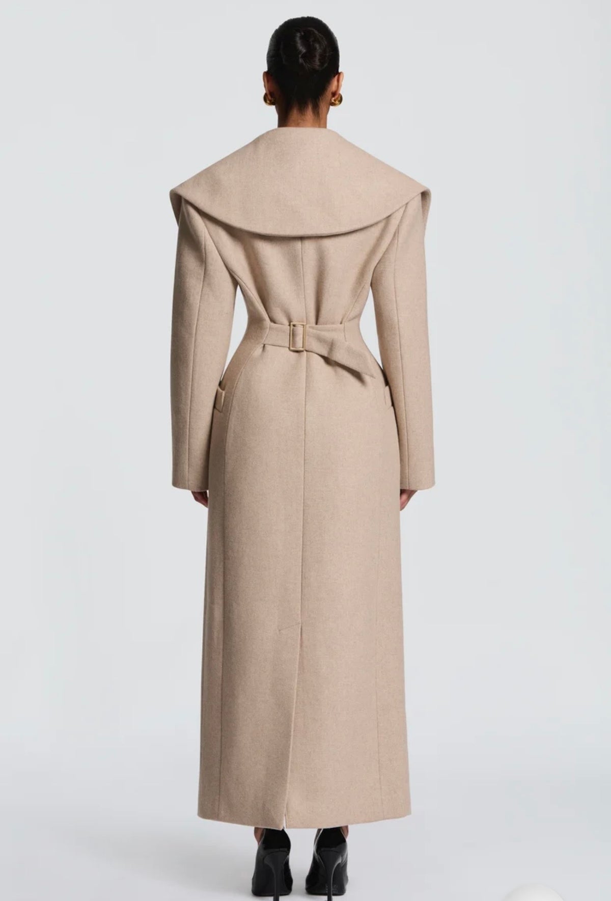 Cappotto Lungo Sartoriale con Maximantellina Un capospalla scenografico e di classe che ridefinisce l'eleganza invernale. Caratterizzato da un'ampia mantellina sulle spalle e una silhouette clessidra accentuata dal punto vita segnato.
