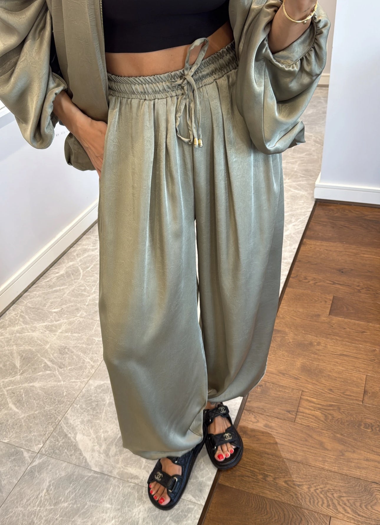 Coordinato PRISCILLA Completo elegante e versatile in tessuto satinato composto da giacca leggera oversize con zip e pantaloni ampi a vita alta con coulisse. Perfetto per look chic e confortevoli, dal giorno alla sera.