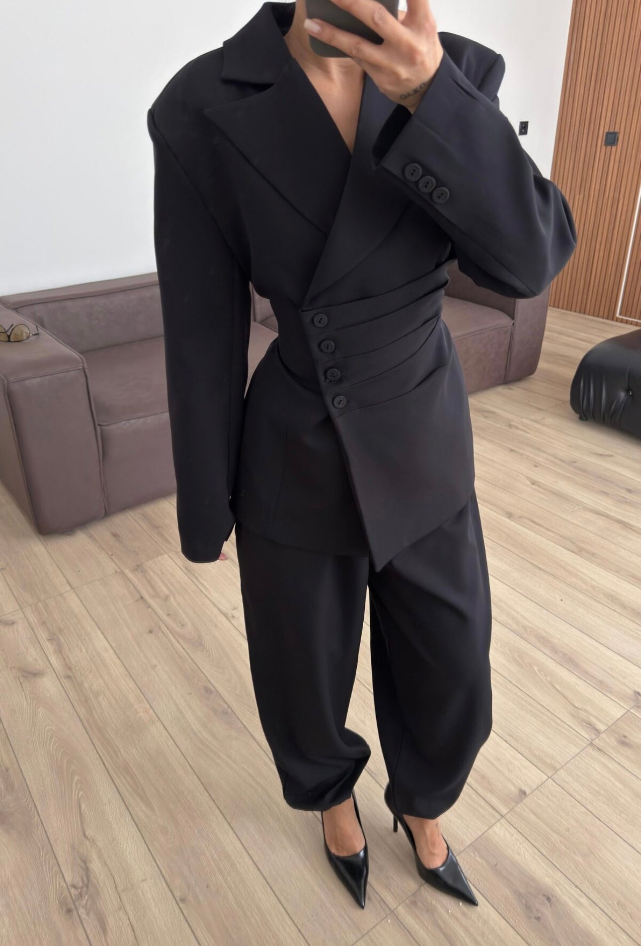 Tailleur Samantha”in promo” composto da giacca sartoriale con spalle strutturate e chiusura incrociata. La cintura integrata con bottoni decorativi stringe il punto vita valorizzando la silhouette e creando un elegante effetto corsetto l pantalone fluido