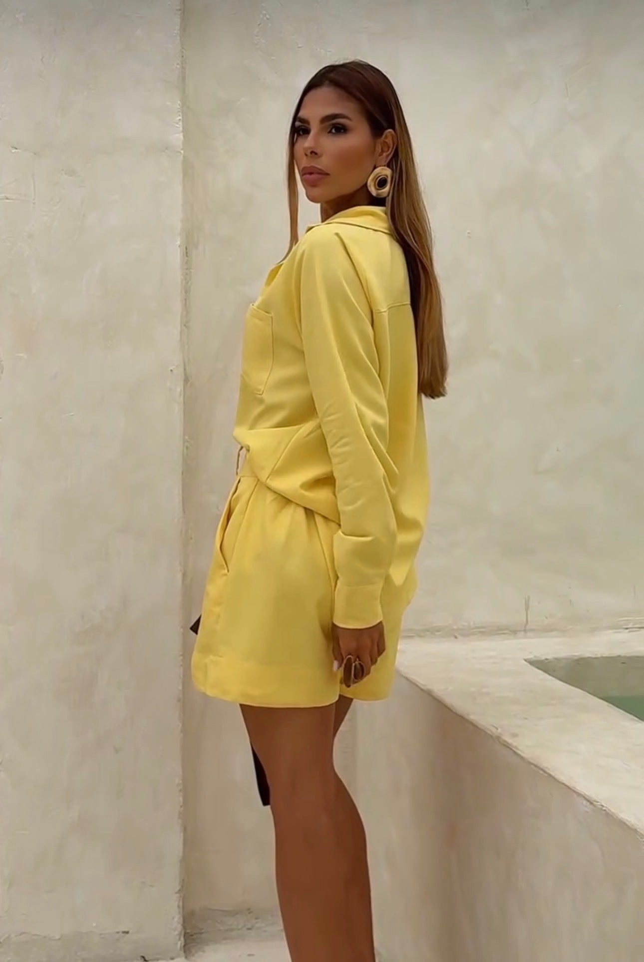 Coordinato Camilla camicia e shorts perfetto per la donna che ama uno stile curato anche nel tempo libero. Il coordinato
è composto da una camicia a maniche lunghe con colletto classico, taschino sul petto e bottoni centrali, abbinata a shorts sartoriali
