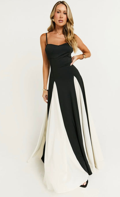 Abito BENEDETTA è un elegante vestito lungo con un design bicolore. La parte superiore con sottili spalline rimovibile mentre la gonna è ampia e fluida, caratterizzata da pannelli alternati di colore nero e bianco