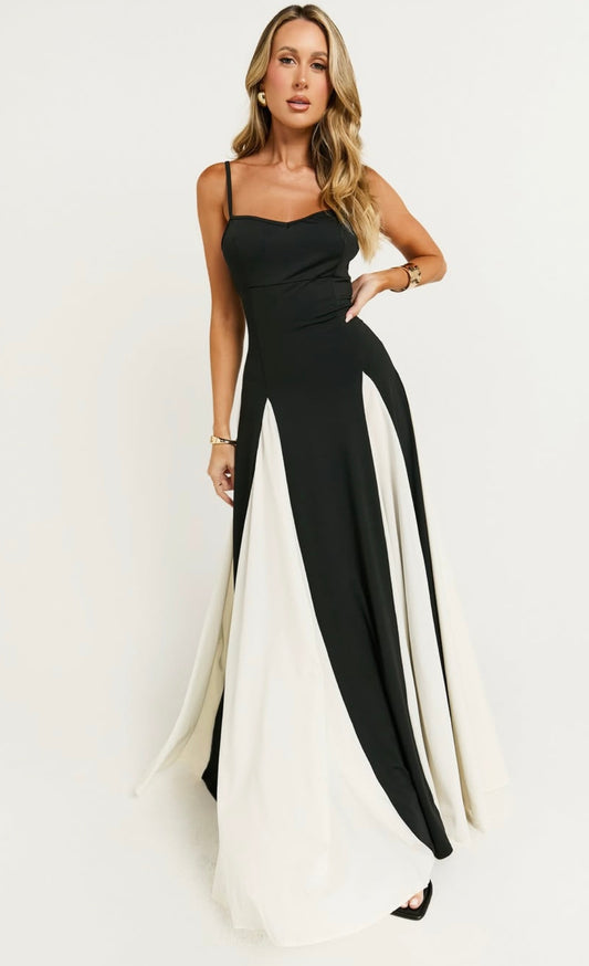 Abito BENEDETTA è un elegante vestito lungo con un design bicolore. La parte superiore con sottili spalline rimovibile mentre la gonna è ampia e fluida, caratterizzata da pannelli alternati di colore nero e bianco