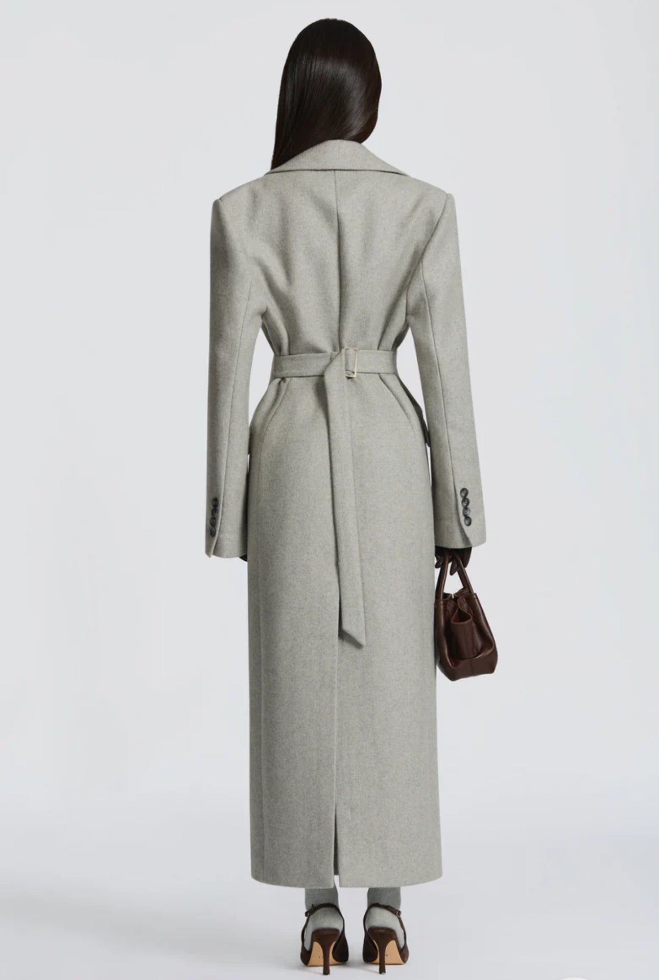 Cappotto ANGELICA lungo grigio in lana, con bottoni frontali e maxi revers a scialle. La linea dritta e sartoriale slancia la figura, mentre il colletto ampio aggiunge un tocco sofisticato. Perfetto per look invernali raffinati, dal giorno alla sera.